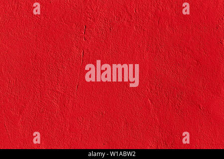flat deep red chili pepper color plaster wall matte texture. Stock Photo