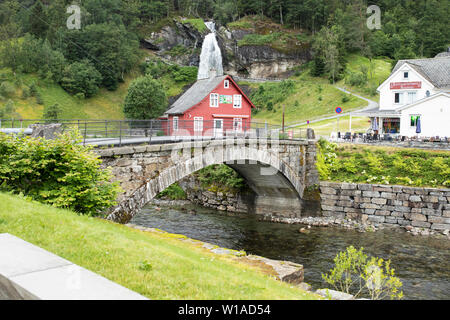 Steinsdals bridge over the Steinsdalselva river in Norheimsund, Norway, with Steinsdalsfossen waterfall in the background. Stock Photo