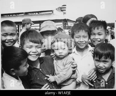 A new market for Tinh Thuong. Children gather before the market which was built with assistance from the government of Vietnam and USAID., 1958 - 1974; General notes:  Use War and Conflict Number 409 when ordering a reproduction or requesting information about this image. Stock Photo