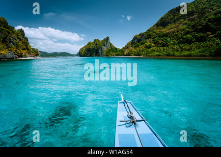 Boat trip to tropical islands El Nido, Palawan, Philippines. Steep green mountains and blue water lagoon. Discover exploring unique nature, journey to Stock Photo