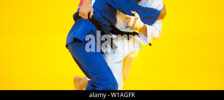 Two judo fighters in white and blue uniform. Stock Photo