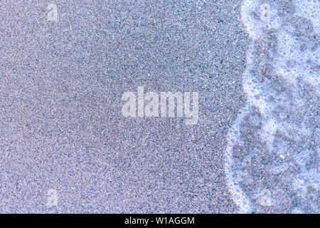 Sand on the sea beach and waves of sea water. Creative vintage background Stock Photo