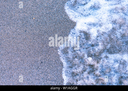 Sand on the sea beach and waves of sea water. Creative vintage background Stock Photo