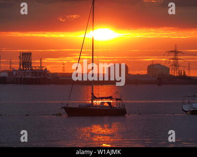 Queenborough, Kent, UK. 1st July, 2019. UK Weather: a dramatic sunset in Queenborough, Kent at the end of another warm day in the South East. Credit: James Bell/Alamy Live News Stock Photo