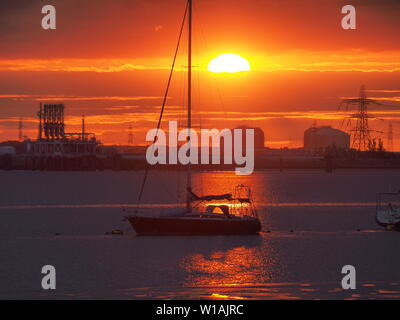 Queenborough, Kent, UK. 1st July, 2019. UK Weather: a dramatic sunset in Queenborough, Kent at the end of another warm day in the South East. Credit: James Bell/Alamy Live News Stock Photo