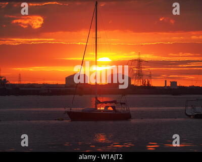 Queenborough, Kent, UK. 1st July, 2019. UK Weather: a dramatic sunset in Queenborough, Kent at the end of another warm day in the South East. Credit: James Bell/Alamy Live News Stock Photo