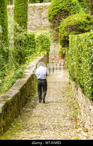 LAKE COMO, ITALY - JUNE 2019: Person walking down a narrrow cobbled path on the route of the Greenway del Lago di Como. Stock Photo