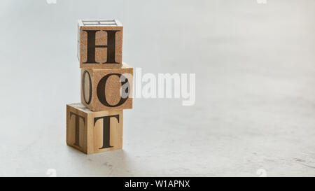 Pile with three wooden cubes - letters HOT on them, space for more text / images on right side. Stock Photo