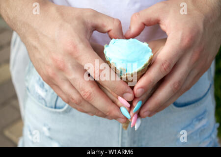 Close-up male and female hand formed a heart shape holding ice cream, concept of love Stock Photo