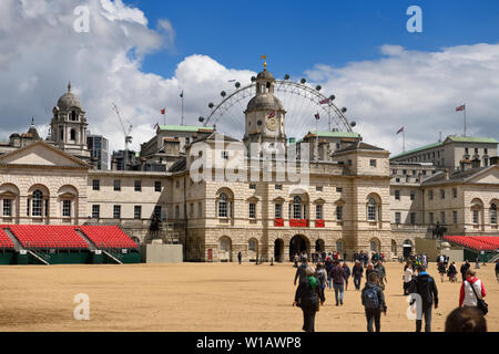 The Household Cavalry Museum at the Horse Guards Parade Westminster London England with crowds and the London Eye Stock Photo