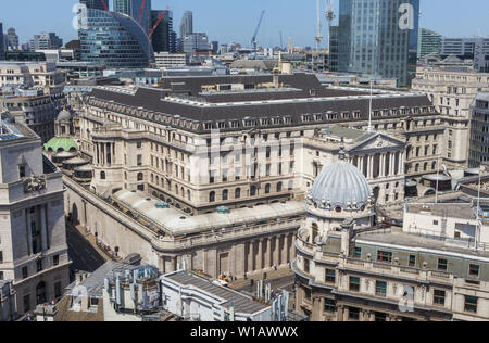 Rooftop view of the Bank of England headquarters building in Threadneedle Street surrounded by old and modern buildings in the City of London financial district, EC2 Stock Photo