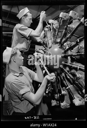 Aviation machinists mates at Navy Pier, Chicago, Illinois. Students working on a complex aircraft engine.; General notes:  Use War and Conflict Number 840 when ordering a reproduction or requesting information about this image. Stock Photo