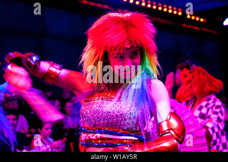 A Japanese dancer in a wig performing a show at the Robot Restaurant, Tokyo, Japan Stock Photo