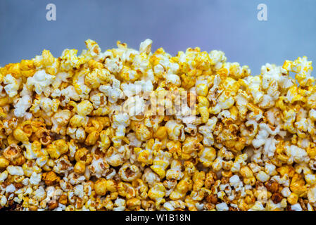 Golden caramel popcorn closeup. Background of popcorn. Snacks and food for a movie Stock Photo