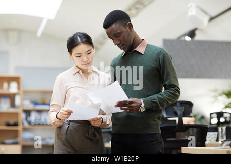 Portrait of diverse business people discussing project in office, copy space Stock Photo