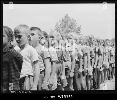 Before meals campers form in 4 lines each line representing an Indian Tribe. The tribe with the straightest line receives a point. At end of camp period points are added and winning tribe receives award. Koppers Recreation Camps, Inc. Camp Thomas E. Lightfoot, Hinton, Summers County, West Virginia. Stock Photo