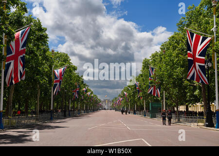 The Mall with Union Jack flags now empty after Trooping the Color 2019 in the City of Westminster London England with Queen Victoria Memorial and Buck Stock Photo