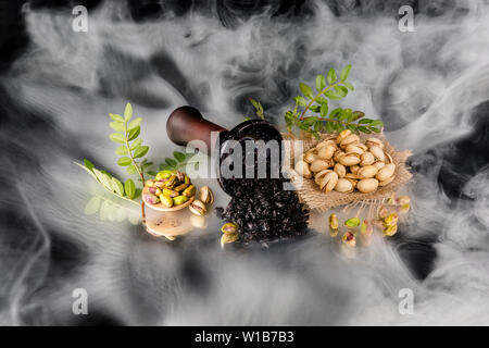 Hookah bowl with tobacco in the smoke. Pistachio shisha tobacco. Stock Photo