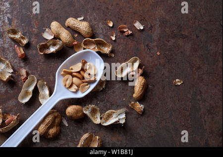Peeled peanut on the rusty metal floor Stock Photo