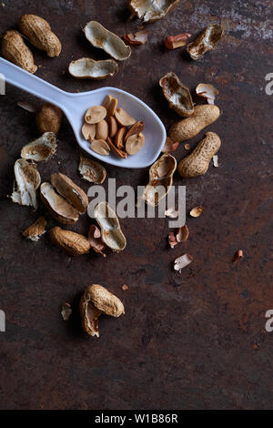 Peeled peanut on the rusty metal floor Stock Photo