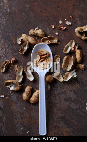 Peeled peanut on the rusty metal floor Stock Photo