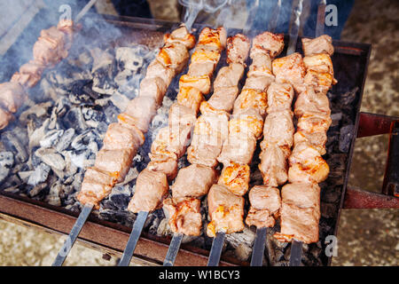 Shish kebab of meat skewered on a grill close-up outdoors Stock Photo -  Alamy