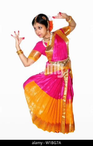 Full length portrait of young woman performing Bharatanatyam classical dance posture isolated on white background Stock Photo