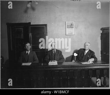 Charles County, Maryland. The executive secretary of the Charles County Welfare Board presents a pro . . .; Scope and content:  Full caption reads as follows: Charles County, Maryland. The executive secretary of the Charles County Welfare Board presents a problem before the county commissioners at their regular monthly meeting, at LaPlata. Around these three Charles County commissioners, county business, problems and policies revolve. Stock Photo