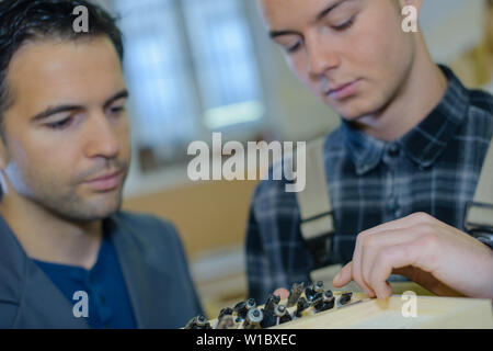 two male masters work in the workshop Stock Photo