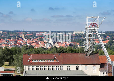 27 June 2019, Saxony, Freiberg: Panoramic view over the daily installations of the shaft "Reiche Zeche" of the colliery "Himmelfahrt Fundgrube" to the city Freiberg. Freiberg is the oldest and most important silver mining area in the Erzgebirge. The region applies for the title on the Saxon side with seventeen, on the Czech side with five parts. The selected monuments, natural and cultural landscapes represent the most important mining areas and epochs of Saxon-Bohemian ore mining as witnesses of 800 years of history. The pits "Reiche Zeche" and "Alte Elisabeth" are still used by the TU Bergak Stock Photo
