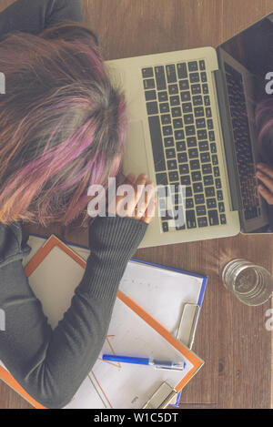 Top view of young freelancer sleeping on laptop keyboard Stock Photo