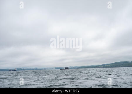 A line of modern russian military submarine cruisers in the row, northern fleet and baltic sea fleet in the open sea, submarine. Stock Photo