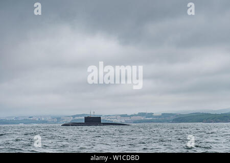 A line of modern russian military submarine cruisers in the row, northern fleet and baltic sea fleet in the open sea, submarine. Stock Photo