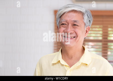 Asian senior man smile in living room at home,Happy aging at home concept. Stock Photo