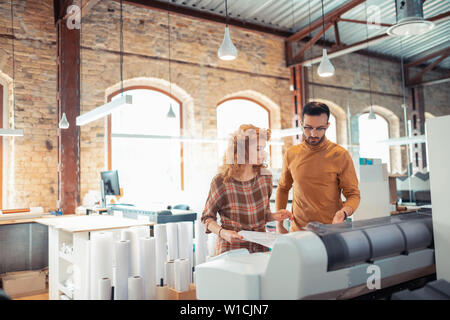 Interior designers working. Two hard-working interior designers working in spacious office together Stock Photo