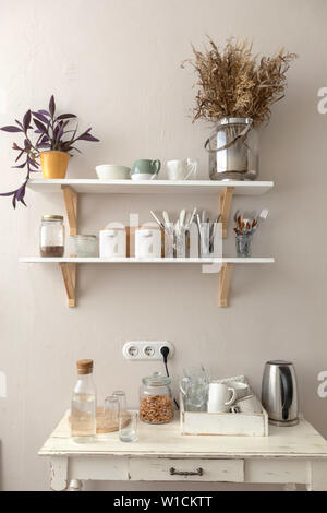 Pots with various houseplants and assorted dishware Stock Photo