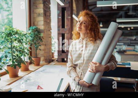 Promising interior designer. Beautiful promising interior designer feeling excited before starting project Stock Photo