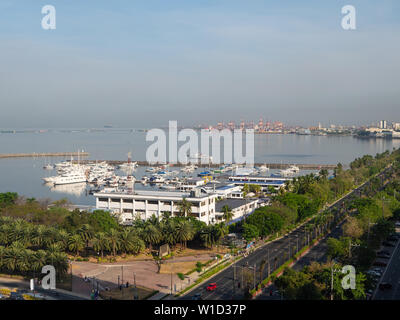 Manila, the Philippines - March 31, 2019: Downtown Manila with Roxas Boulevard, the Navy Headquarters and Manila Yacht Club in the foreground and the Stock Photo