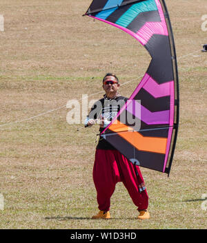 Pasir Gudang, Malaysia - March 3, 2019: Chinese kite flier Yao Qingshan flying a quad line kite on short lines at the 24th Pasir Gudang World Kite Fes Stock Photo