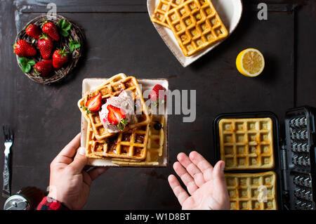 Chef serving freshly made waffle dessert first person view Stock Photo