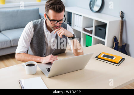 Man working on laptop from home - home office concept Stock Photo