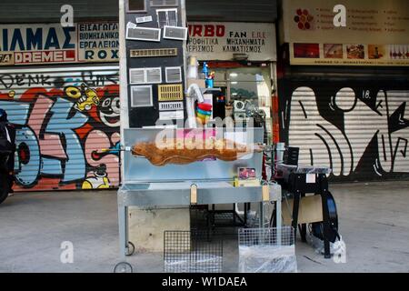 a plastic roast on a spitroast unit outside athens cookware shop greece Stock Photo