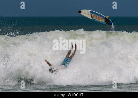 Surfer's crash on the high wave in Bali Stock Photo