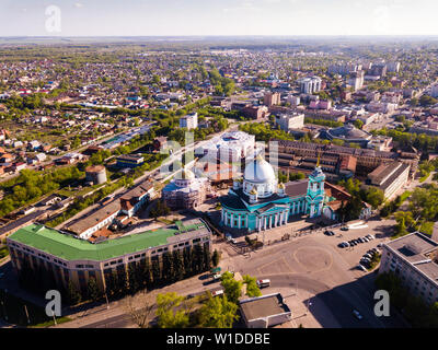 Aerial view of architectural ensemble of monastery of Our Lady of Kursk with Znamensky Cathedral on background of modern cityscape, Russia