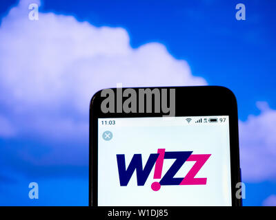 In this photo illustration the Wizz Air logo is seen displayed on a smartphone Stock Photo