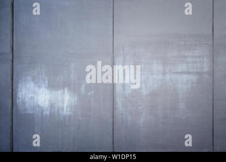 High resolution full frame background of a concrete wall painted in gray with lighter marks as a result of graffiti removal. Copy space and vignetting Stock Photo