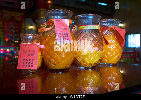 Glass pineapple candle jars lined up at Tua Pek Kong Chinese temple in Bintulu, Borneo, Malaysia. Stock Photo