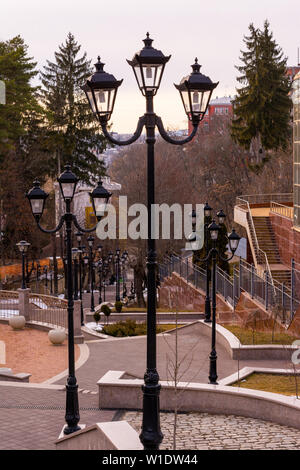 A large number of night lanterns on the sides of a tiled staircase leading down - a resort town, cityscape. Stock Photo