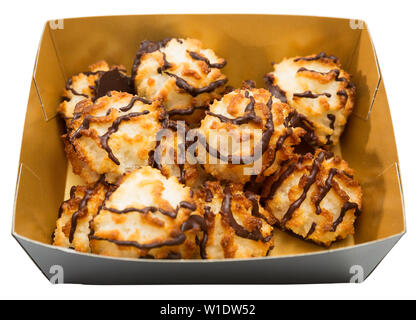 Coconut macaroons in chocolate glaze in carton box. Delicate baked dessert. Isolated over white background Stock Photo