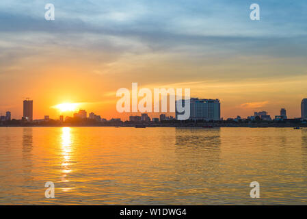 Phnom Penh skyline at sunset capital city of Cambodia kingdom, panorama silhouette view  from Mekong river, travel destination, dramatic sky Stock Photo